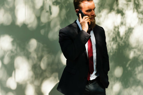 man in a suit talking on the phone